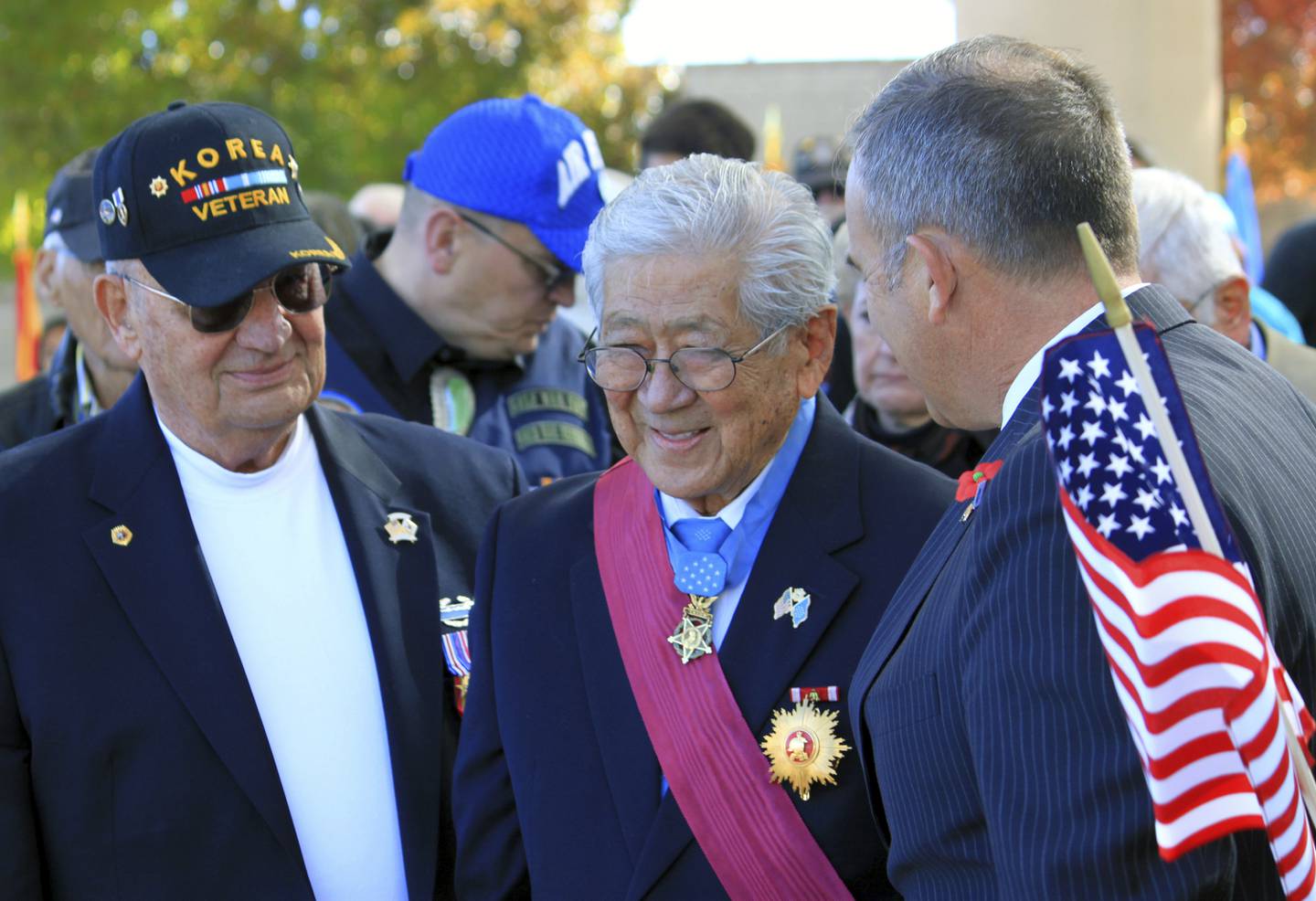 FILE - People stand to honor Medal of Honor recipient Hiroshi Miyamura, center, during a Veterans Day ceremony at the New Mexico Veterans Memorial in Albuquerque, N.M., on Nov. 11, 2014. (Susan Montoya Bryan/AP, File)